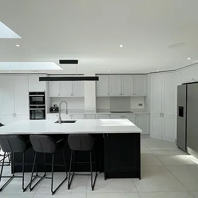 large white kitchen with black chairs