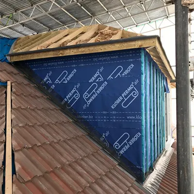 the roof of a building with a blue tarp covering it