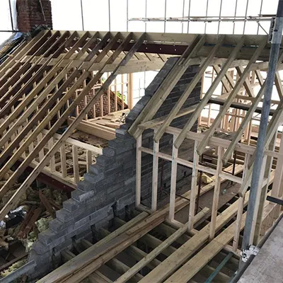a house being built with wooden framing